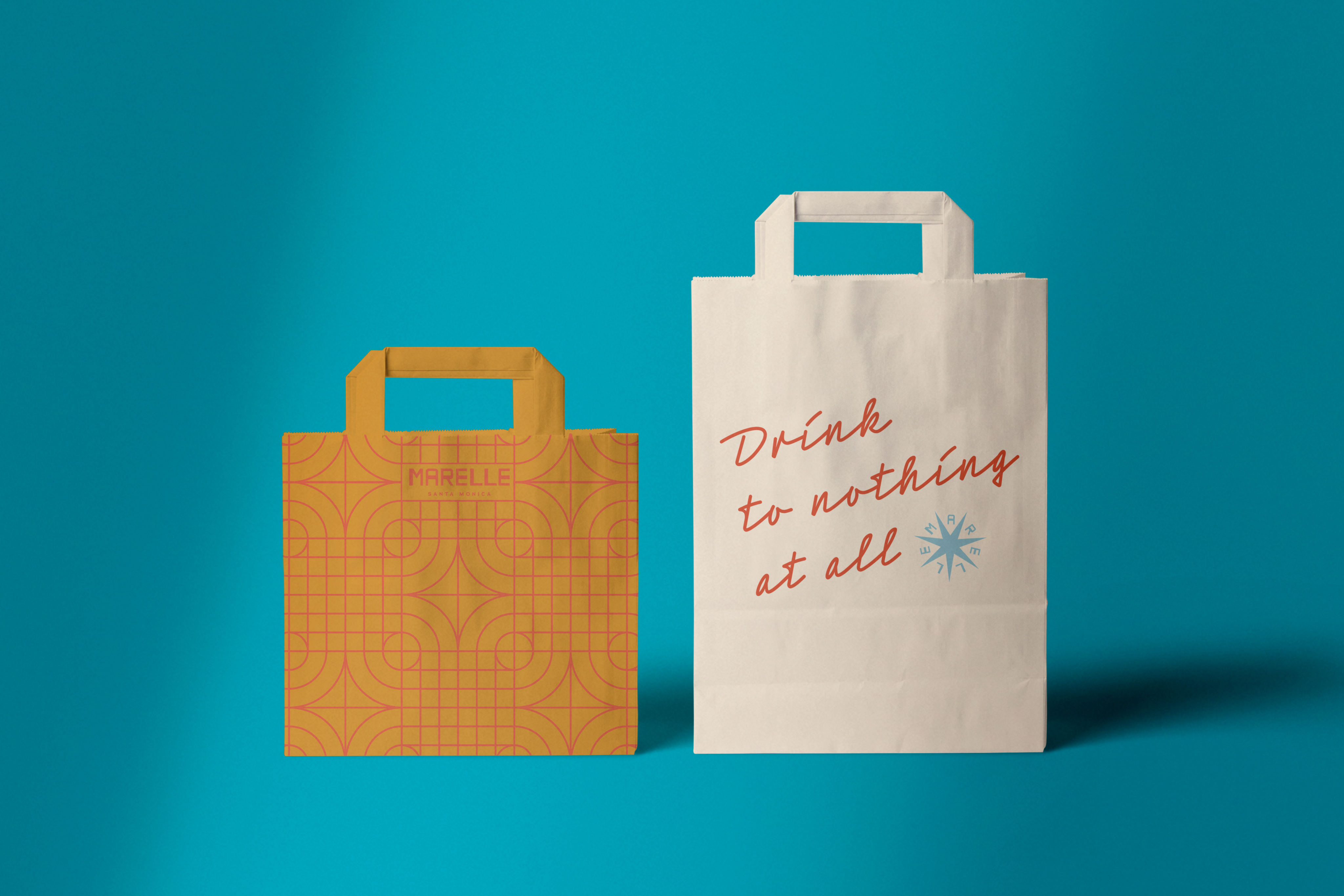 Two paper shopping bags on a blue background; one is yellow with a geometric pattern, the other is white with red text reading "Drink to nothing at all," hinting at beverage and food themes, and a small blue snowflake design.