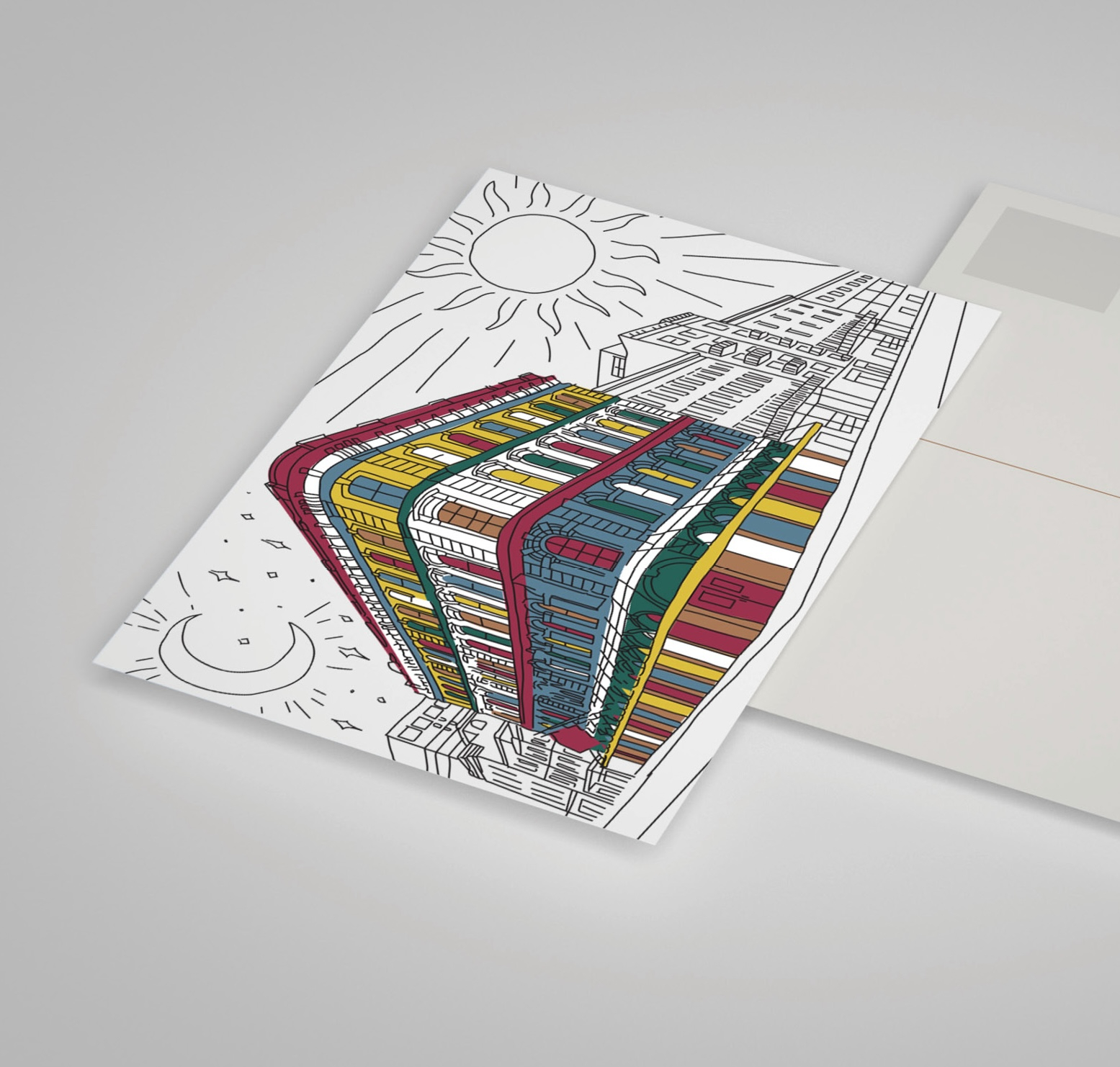 A postcard featuring a colorful illustration of a tall, multi-story building under the sun and moon, partially slid out from an envelope.